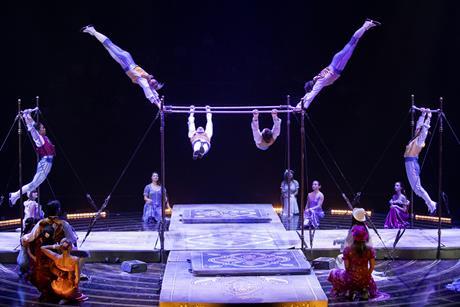 Acrobats perform on bars as part of Cirque du Soleil's performance of Corteo