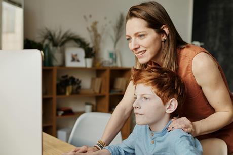 A parent with a child in front of the computer