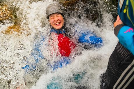 One pupil immersed in water on an Outward Bound Trust residential