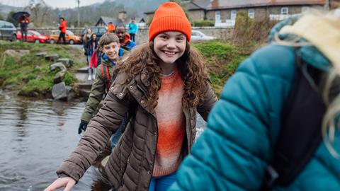 Pupils crossing the river on a school trip