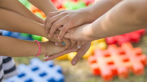 Friendship - children holding hands in a group