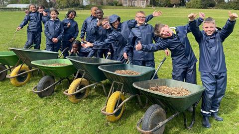 A group of children with their wheelbarrows at Farms for City Children