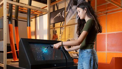 A visitor tries out their welding skills at the Technicians The David Sainsbury Gallery at the Science Museum