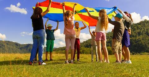 Pupils using a parachute in nature