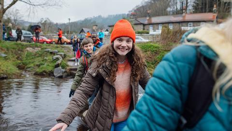 Pupils crossing the river on a school trip