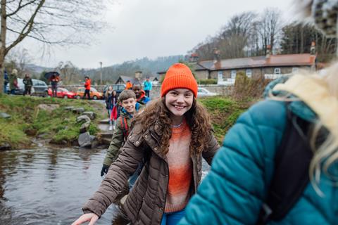 Pupils crossing the river on a school trip