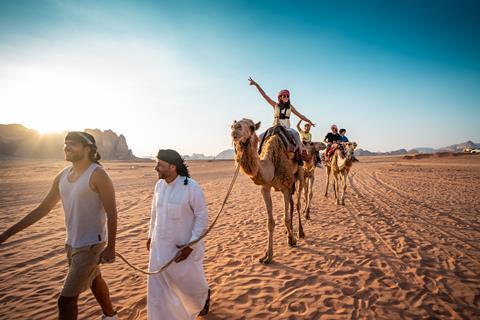 Pupils riding camels in the Jordan desert