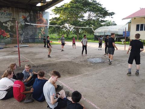 Walsall Academy students playing volleyball with the locals during a forest project in Borneo.