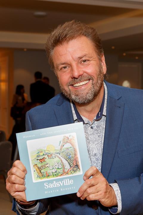 Martin Roberts with his children's book Sadsville in support of the NSPCC