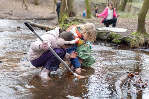 Students taking part in pond dipping as part of a Conway Centres residential