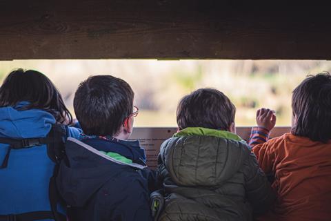 Children bird watching on a school trip