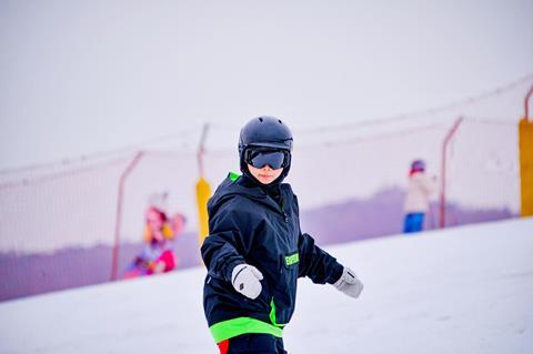 Pupil snow boarding on a school trip in Europe