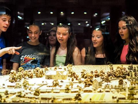 Students look at a model during a school trip to Normandy, France.