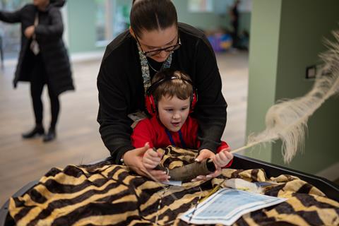 Child with SEND and Teacher at Artefact Table