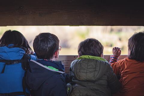 Children bird watching on a school trip