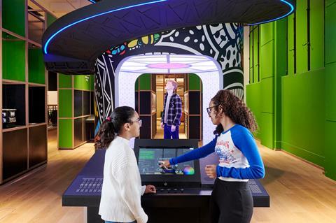 Two teenager girls try out one of the interactives at the Technicians: The David Sainsbury Gallery at the Science Museum