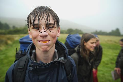 One pupil on a hike with The Outward Bound Trust eating an orange