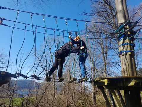 Two teenagers on a high ropes course