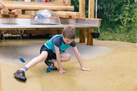 A boy plays in some water