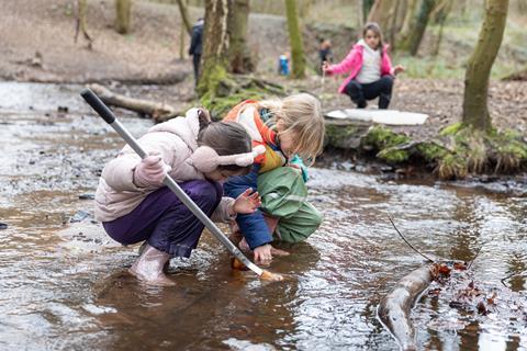 Students taking part in pond dipping as part of a Conway Centres residential
