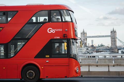 London Bus on a bridge, with Tower Bridge in the background.