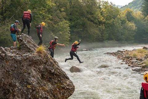 Students leap into a river on a BeVentursome visit