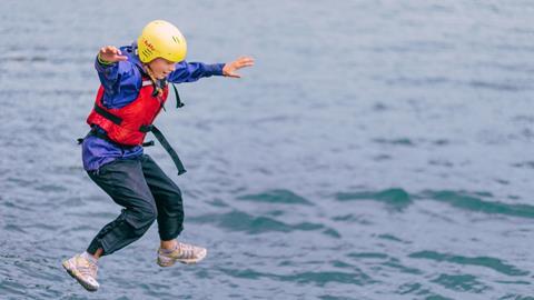 Pupil jumping into the sea at Conway Centres