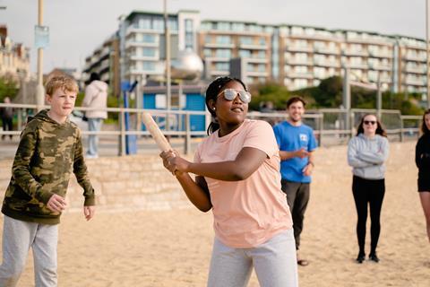 Children playing rounders on the beach
