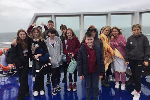 A group of teenagers on the deck of a ferry