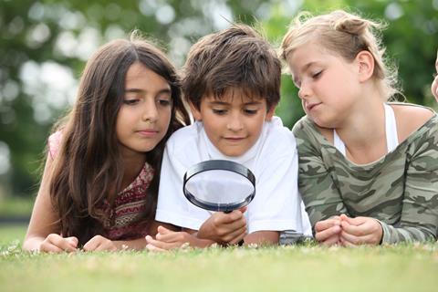 Children with magnifying glass