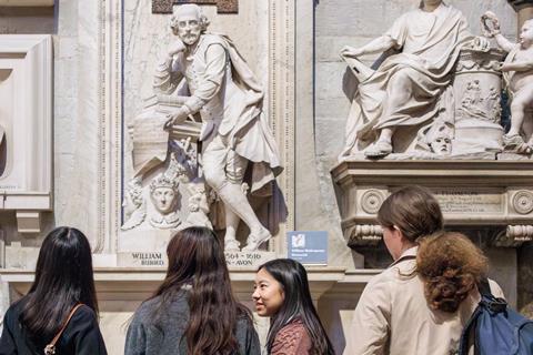 Secondary students looking at sculpture of Shakespeare
