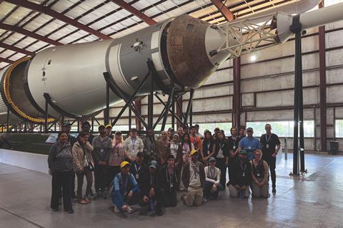 In front of a Saturn V rocket at Johnson Space Center
