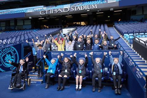 Pupils in the dugout at Manchester City Football Club's Etihad Stadium