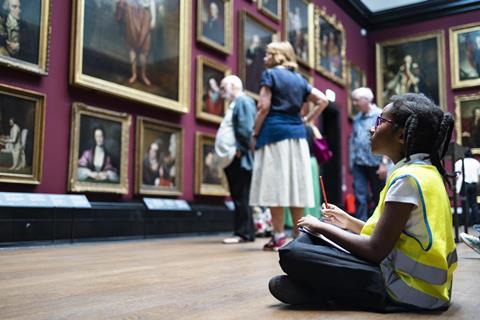 School girl sat on floor of gallery