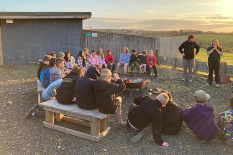 Pupils from LEO Academy Trust around a fire