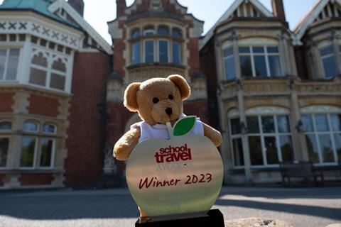 Bletchley Park won the Best Heritage Venue Award at the School Travel Awards, with mascot Teacher Ted and the trophy pictured outside the on-site mansion