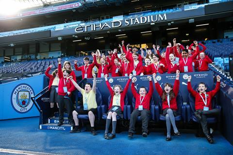 School children in the dugout of Manchester City's Etihad Stadium