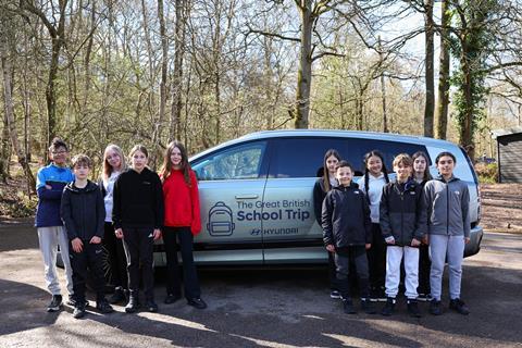 Children in front of a car to promote The Great British School Trip