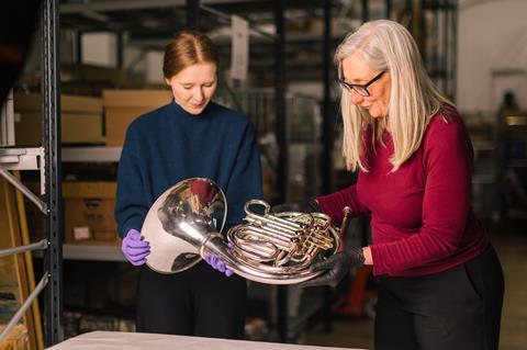 Two people looking at an object at the Royal Marines Experience