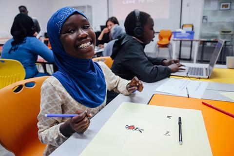 A smiley child takes part in a workshop at the National Videogame Museum