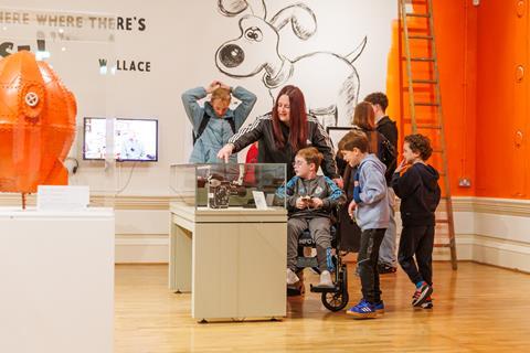 Children and adults explore an exhibition at The Harris, Preston