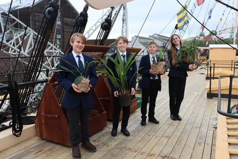 A group of children planting orchids aboard SS Great Britain in Bristol