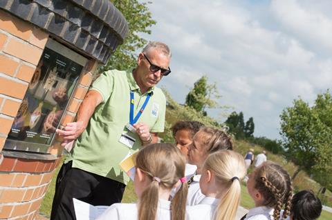 Pupils taking part in educational workshop with a guide at the National Memorial Arboretum