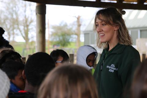 Staff member at ZSL Whipsnade Zoo with school children