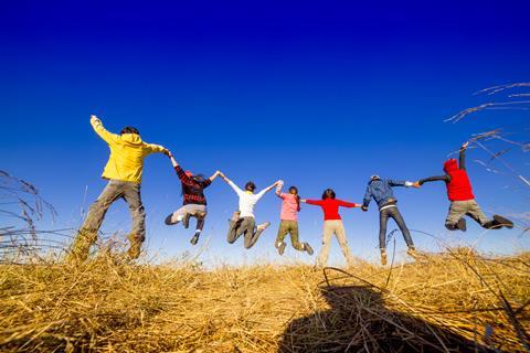 Kids jumping on hill