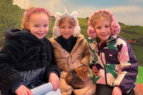 Children from Ferncumbe Church of England School handling guinea pigs at Hatton Adventure World