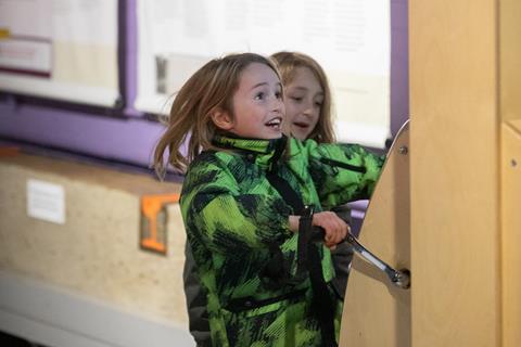 Two children interacting with museum display