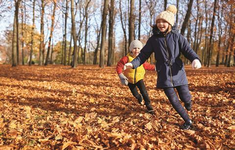 Children running in leaves