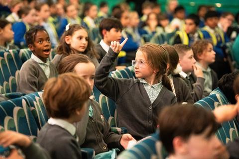 School children sit in a theatre as part of a Q&A session