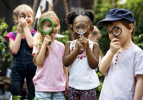 A group of children with magnifying glasses